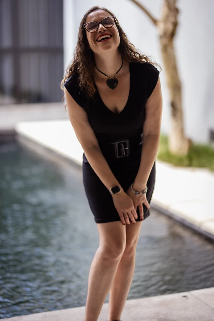 Bia Bliss laughing, standing beside a pool